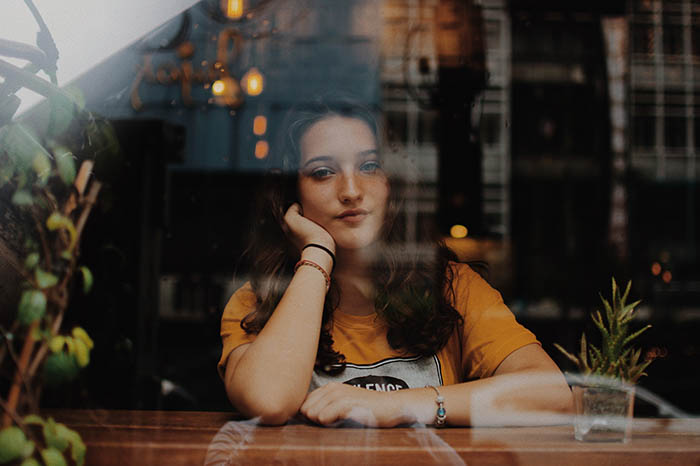 A portrait of a woman in a cafe