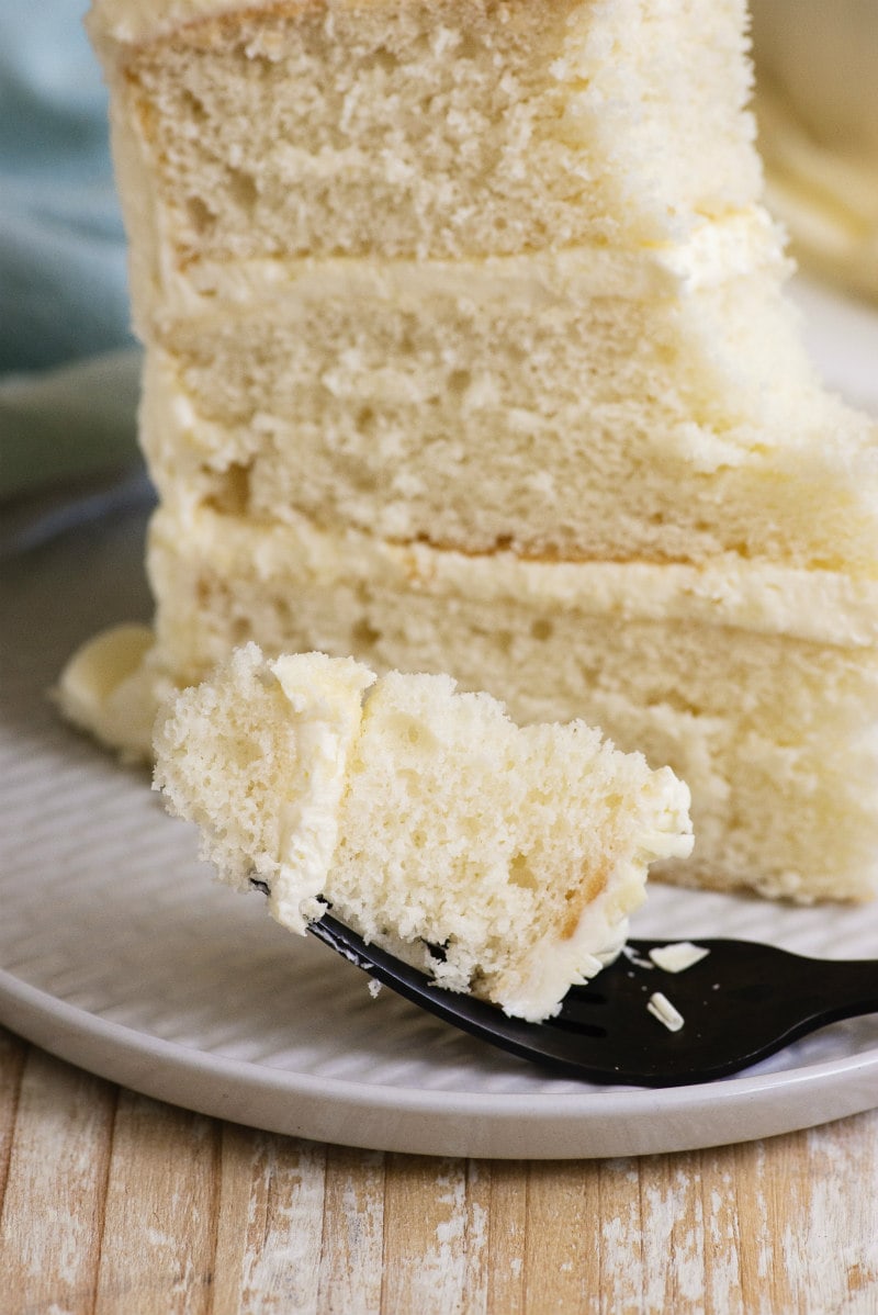 Easy White Wedding Cake recipe from RecipeGirl.com #easy #white #wedding #cake #recipe #RecipeGirl bite of White Wedding Cake on a fork