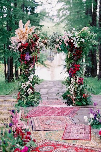 wedding altar decoration boho arch with flowers and chandelier in the aisle lay carpets lev_chudov via instagram